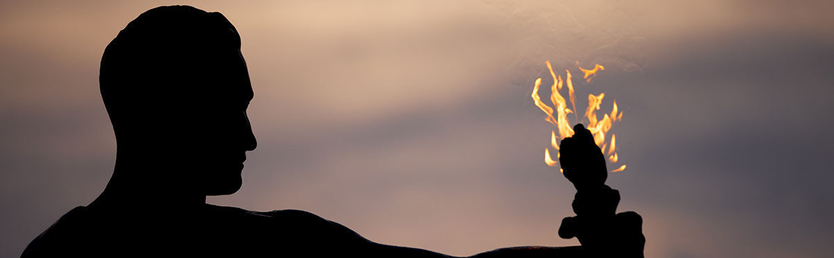 A photo of the torchbearer at night from behind.